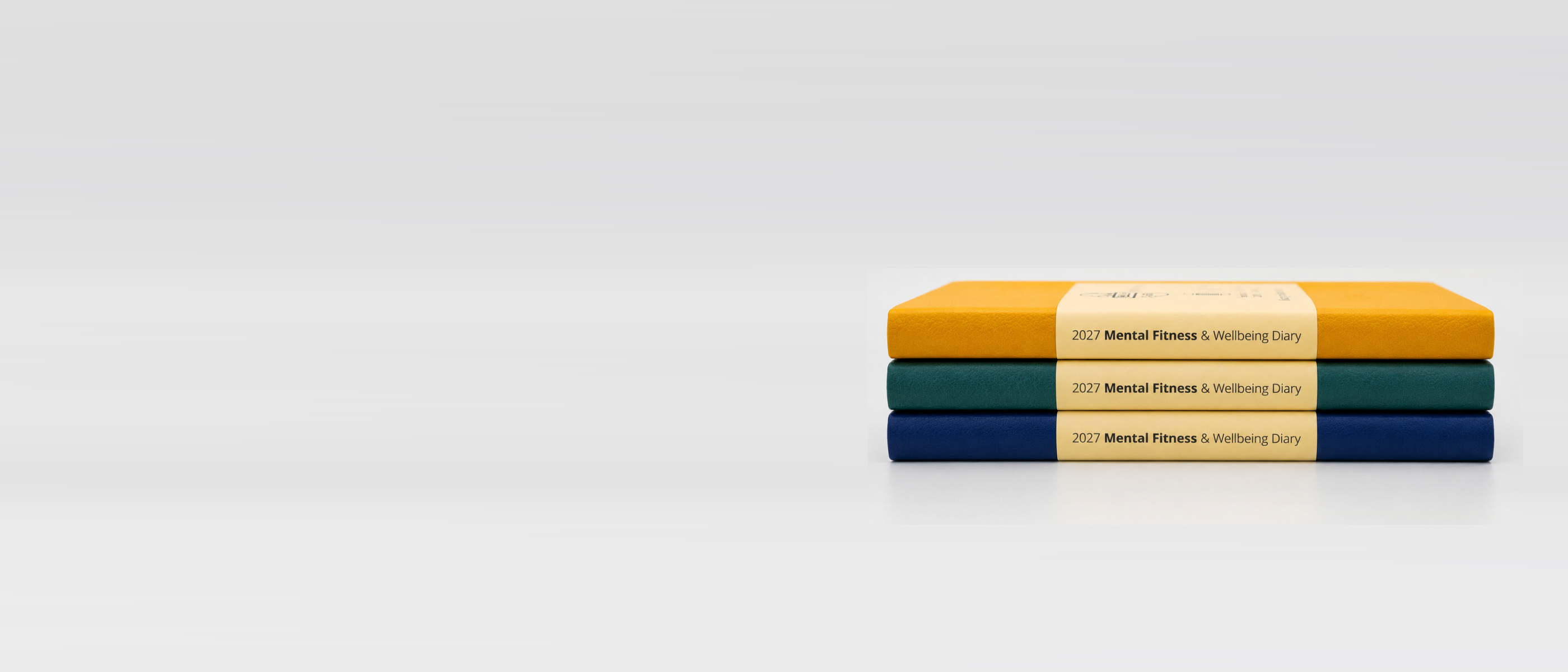This image shows the three colours (Golden Mustard, Forest Green and Classic Navy) of our 2027 Mental Fitness & Wellbeing Diary that helps people build resilience and plan their time for effectively. 